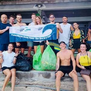Padi Project Aware Specialty Diver course people after collecting trash with padoi aware flag on land