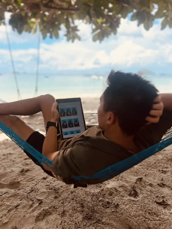 Student readin the online learning material for their dive course on Mae Haad beach in a hammock