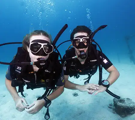 Two Open Water Course student divers from Crystal Dive on Koh Tao Thailand underwater at Twins