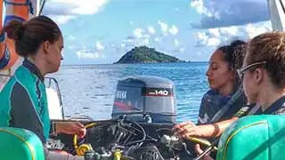 thecoraltribe.com-coral-restoration-girls-boat The coral tribe girls on the boat with dive equipment