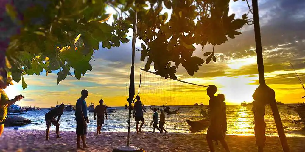 Crystal Dive Mae Haad beach volleyball net and players at sunset Koh Tao diving blog