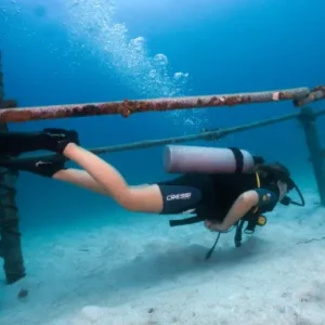 Perfect Buoyancy Specialty diver swimming through the jungle gym at buoyancy world dive site on Koh Tao Thailand