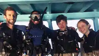 crystaldive.com-divemaster-course-divers-on-boat Crystal Dive fun divers and divemaster on the boat