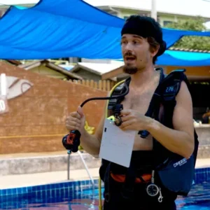 Assistant Instructor Trainer course candidate briefing a skill beside the Crystal Dive pool