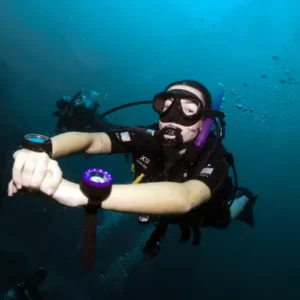 Navigation Specialty student swimming around with compass on wrist on Koh Tao Thailand