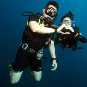 Couple doing Scuba Diver Course in the ocean near Koh Tao Thailand