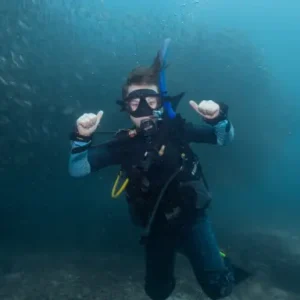 SSI Explorers kid in front of big school of fish on Koh Tao