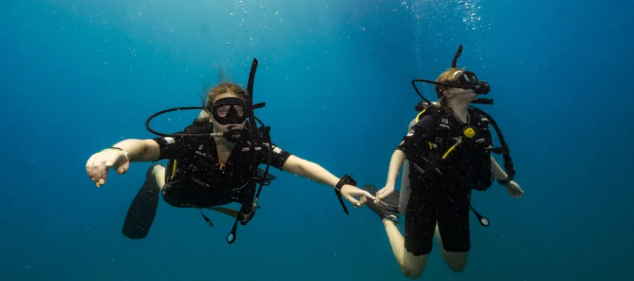 chronicles working as a divemaster two happy divers two girls diving around Koh tao