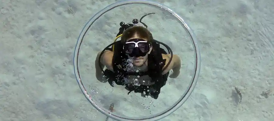 Diver blowing a bubble ring underwater