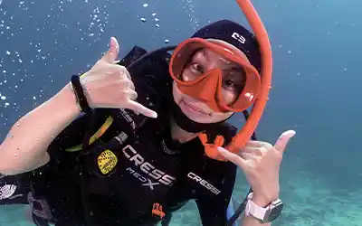 Scuba Diver giving an awesome sign underwater