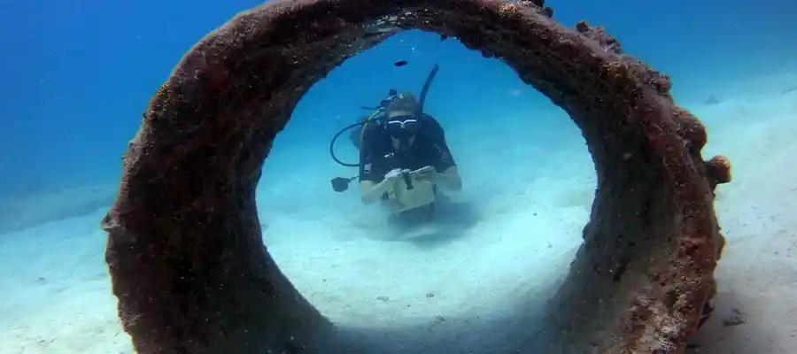 Diver in trim at a swim through
