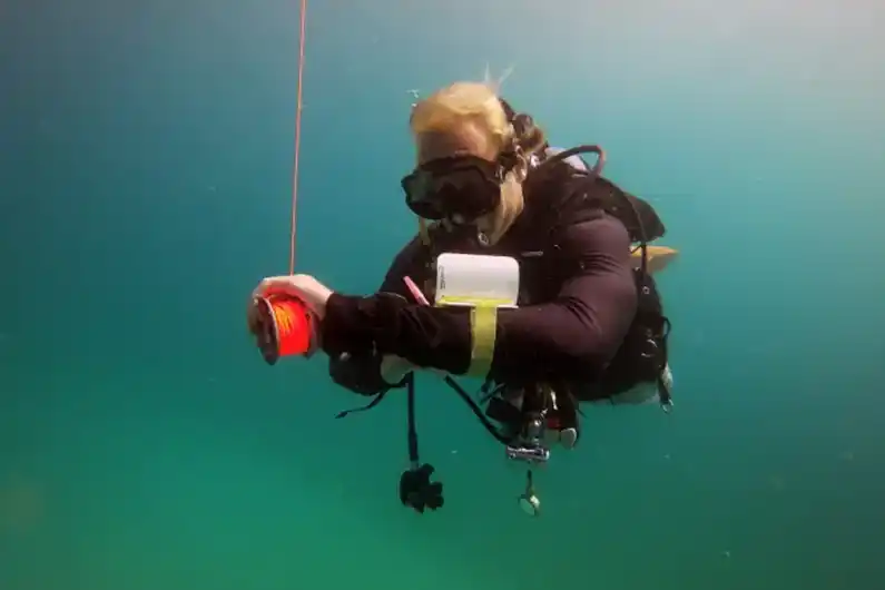 Crystal Dive Decompression Diving Course Thailand Student in Open Water doing deco stop writing on slate