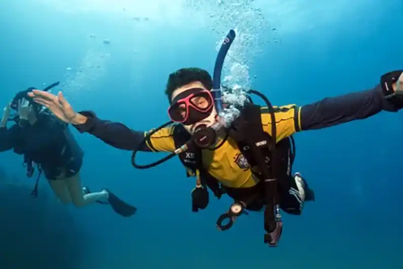 Nitrox specialty course diver arms spread out swimming through the water on Koh Tao Thailand