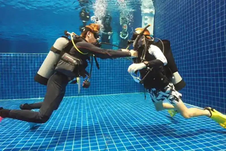 Dive Instructor Course koh tao (ITC) candidates performing air sharing ascent in Crystal Dive pool