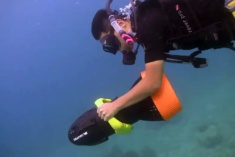 A diver with a Diver Propulsion Vehicle