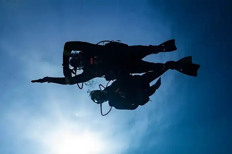 Search and Recover Specialty Diver seen from below performing compass skill