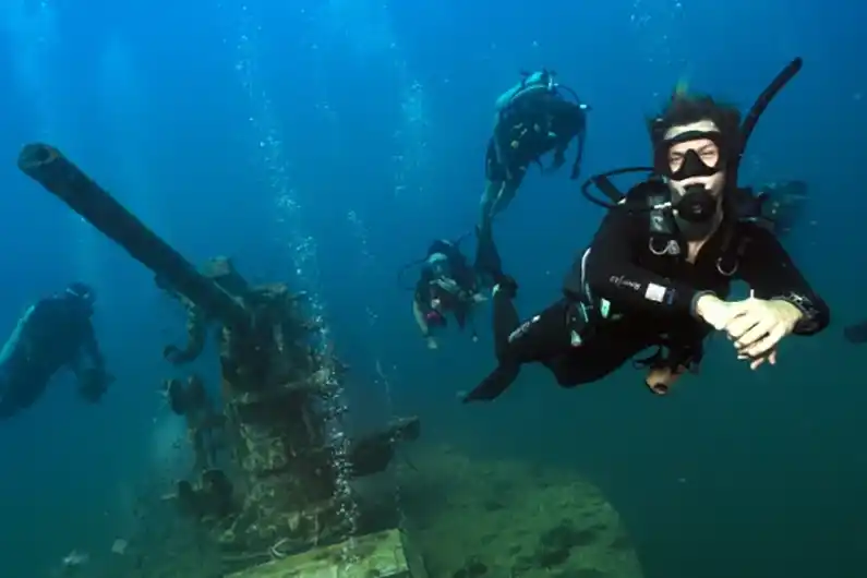 Crystal Dive Instructor And Students Around The Wreck HTMS Sattakut Koh Tao Thailand