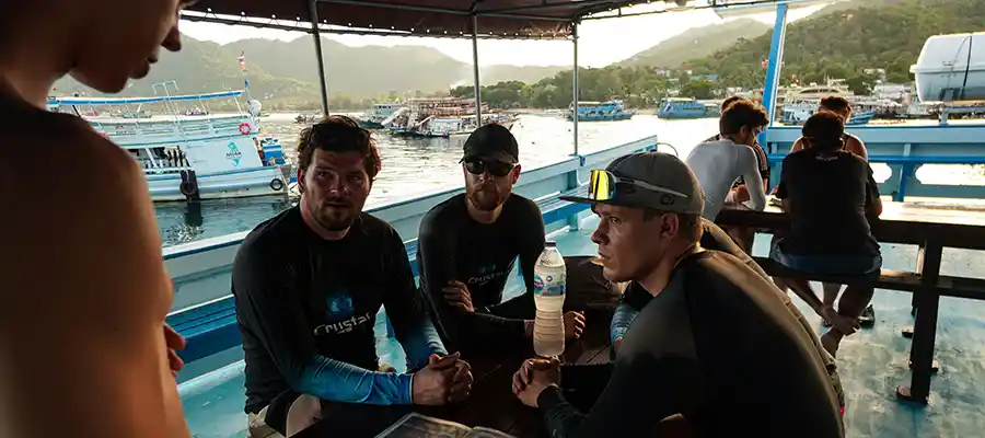 chronicles suncream and scuba boat briefing Scuba Divers getting briefed for their dives